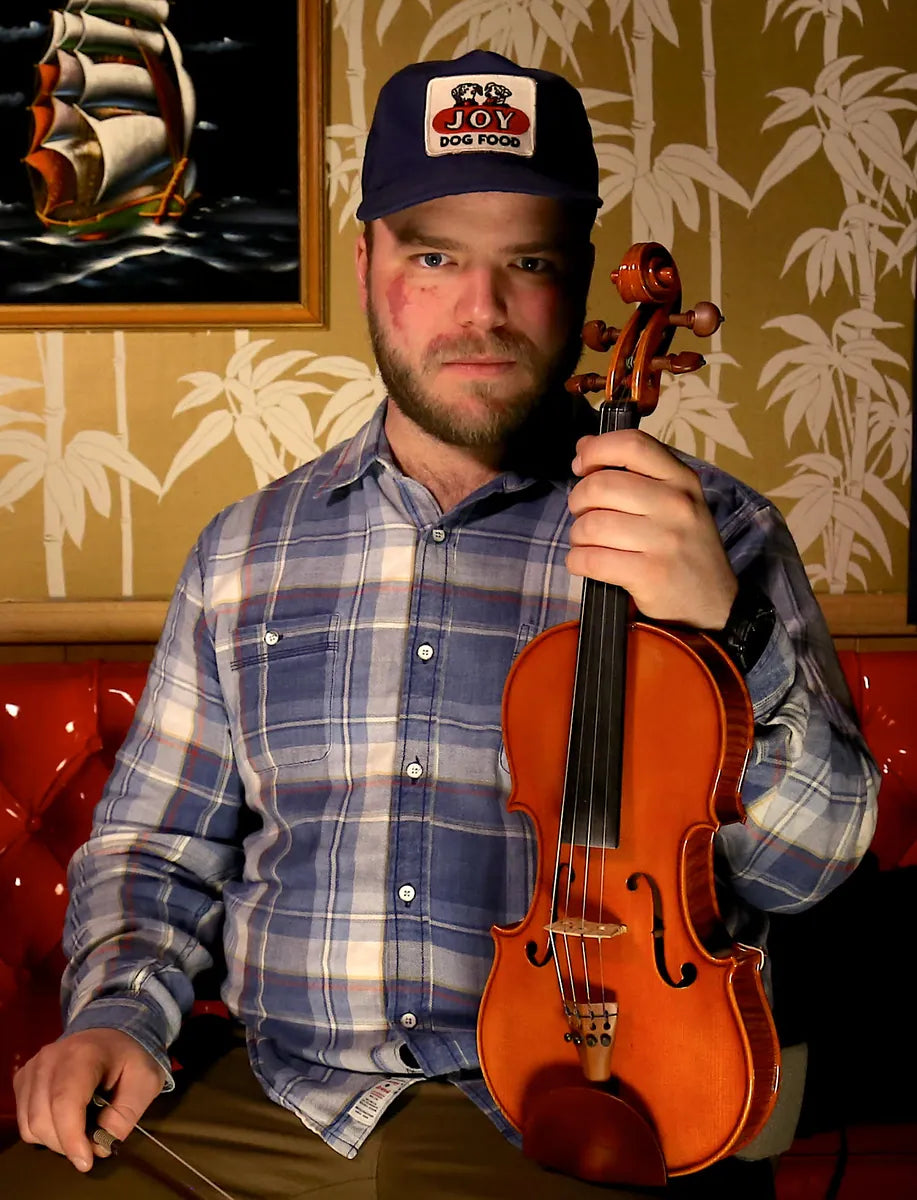 Henry Barnes holding his fiddle, performer at Bristol Sessions Nights: The Blue Yodel in Bristol, Tennessee