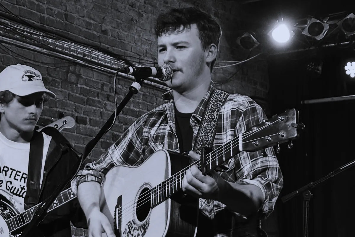 Ryder Casey singing with an acoustic guitar, performer at Bristol Sessions Nights in Bristol, Tennessee