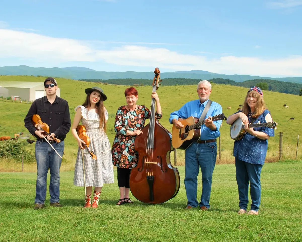 The Whitetop Mountain Band with their instruments in a mountain pasture, performers at Bristol Sessions Nights: The Carter Sessions in Bristol, Tennessee