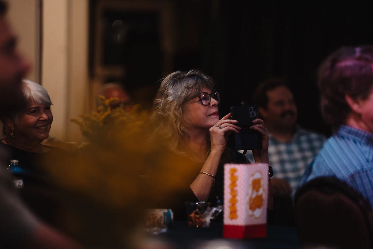 Guests smiling and recording the show on a phone at Bristol Sessions Nights: The First Take, Bristol Listening Room, L.C. King Building, Bristol, Tennessee