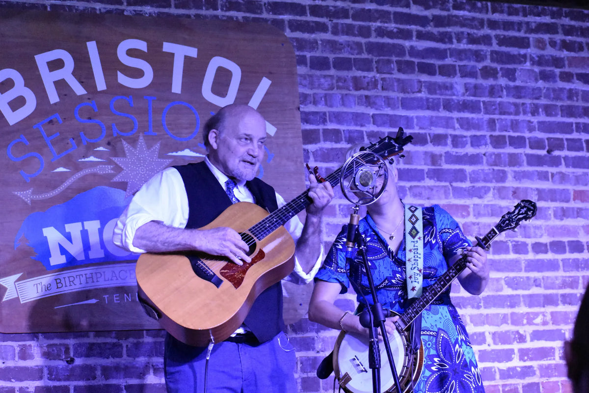 A guitar and banjo duo sharing a song under the Bristol Sessions Nights sign at Bristol Sessions Nights: The Carter Sessions, Bristol Listening Room, L.C. King Building, Bristol, Tennessee