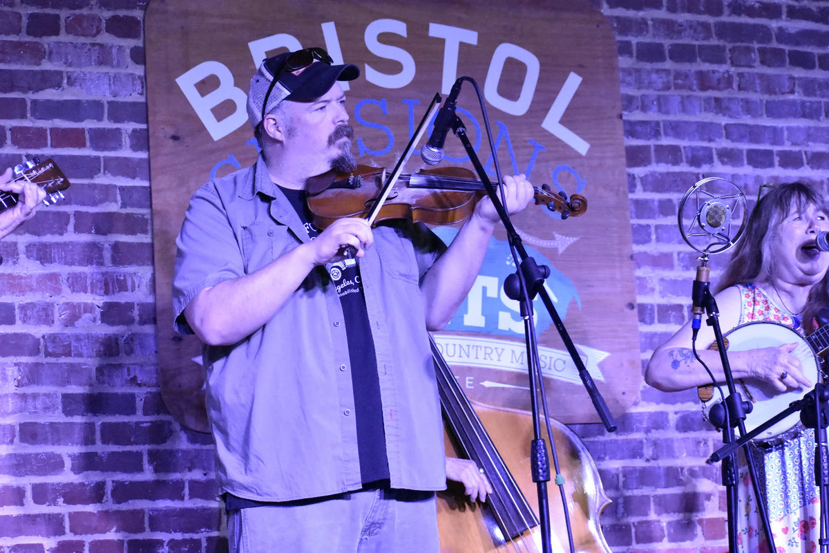 The Whitetop Mountain Band fiddler playing in front of the Bristol Sessions Nights sign at Bristol Sessions Nights: The Carter Sessions, Bristol Listening Room, L.C. King Building, Bristol, Tennessee