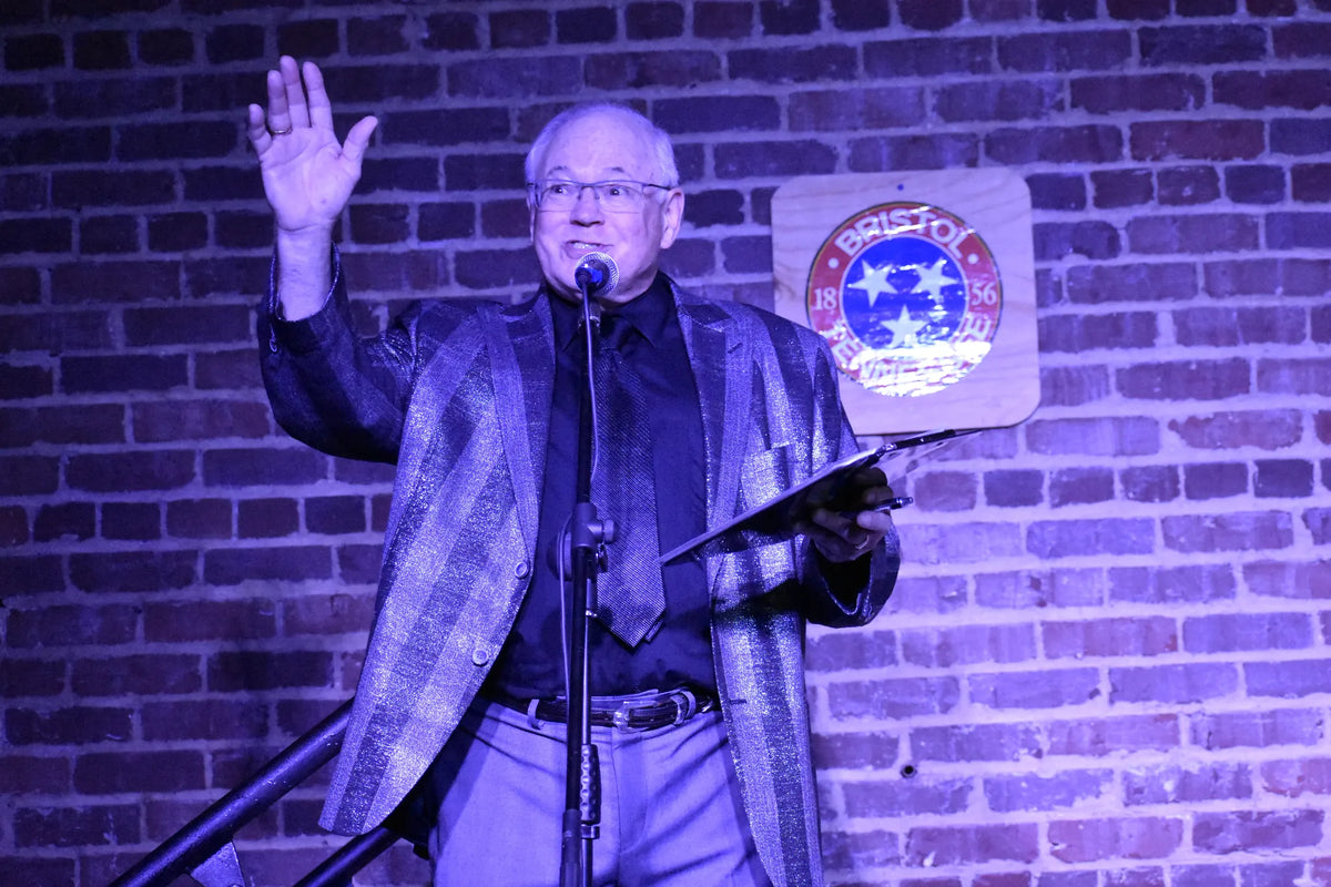 A speaker addresses the crowd with a raised hand at Bristol Sessions Nights: The Carter Sessions, Bristol Listening Room, L.C. King Building, Bristol, Tennessee