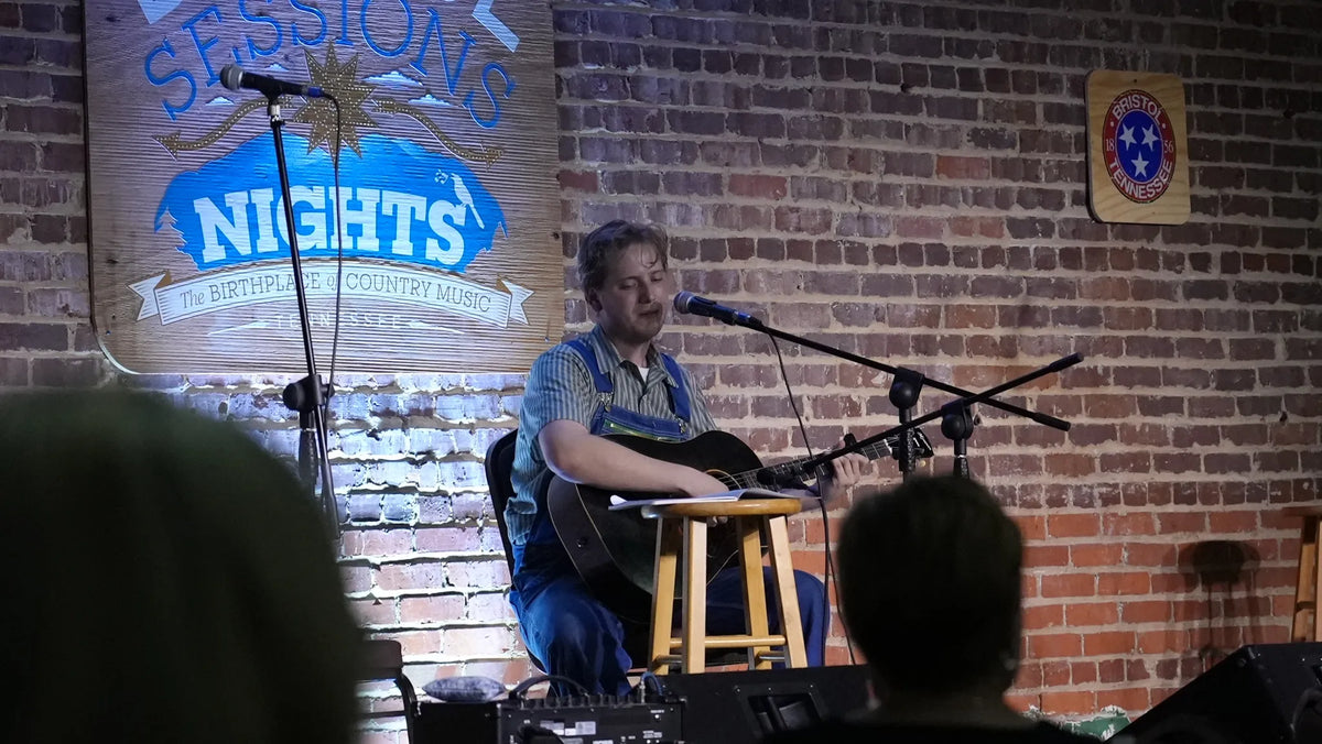 Conner Vlietstra singing with an acoustic guitar at Bristol Sessions Nights: The Blue Yodel, Bristol Listening Room, L.C. King Building, Bristol, Tennessee