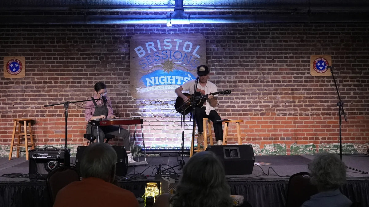 Kris Truelsen and a keyboard player performing under the Bristol Sessions Nights sign at Bristol Sessions Nights: The Blue Yodel, Bristol Listening Room, L.C. King Building, Bristol, Tennessee