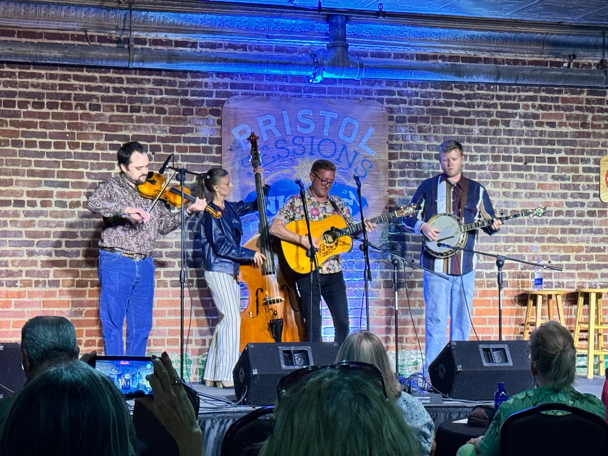 Alex Leach and band play fiddle, upright bass, guitar and banjo as guests film from their seats at Bristol Sessions Nights: Mountain Songs, Bristol Listening Room, L.C. King Building, Bristol, Tennessee