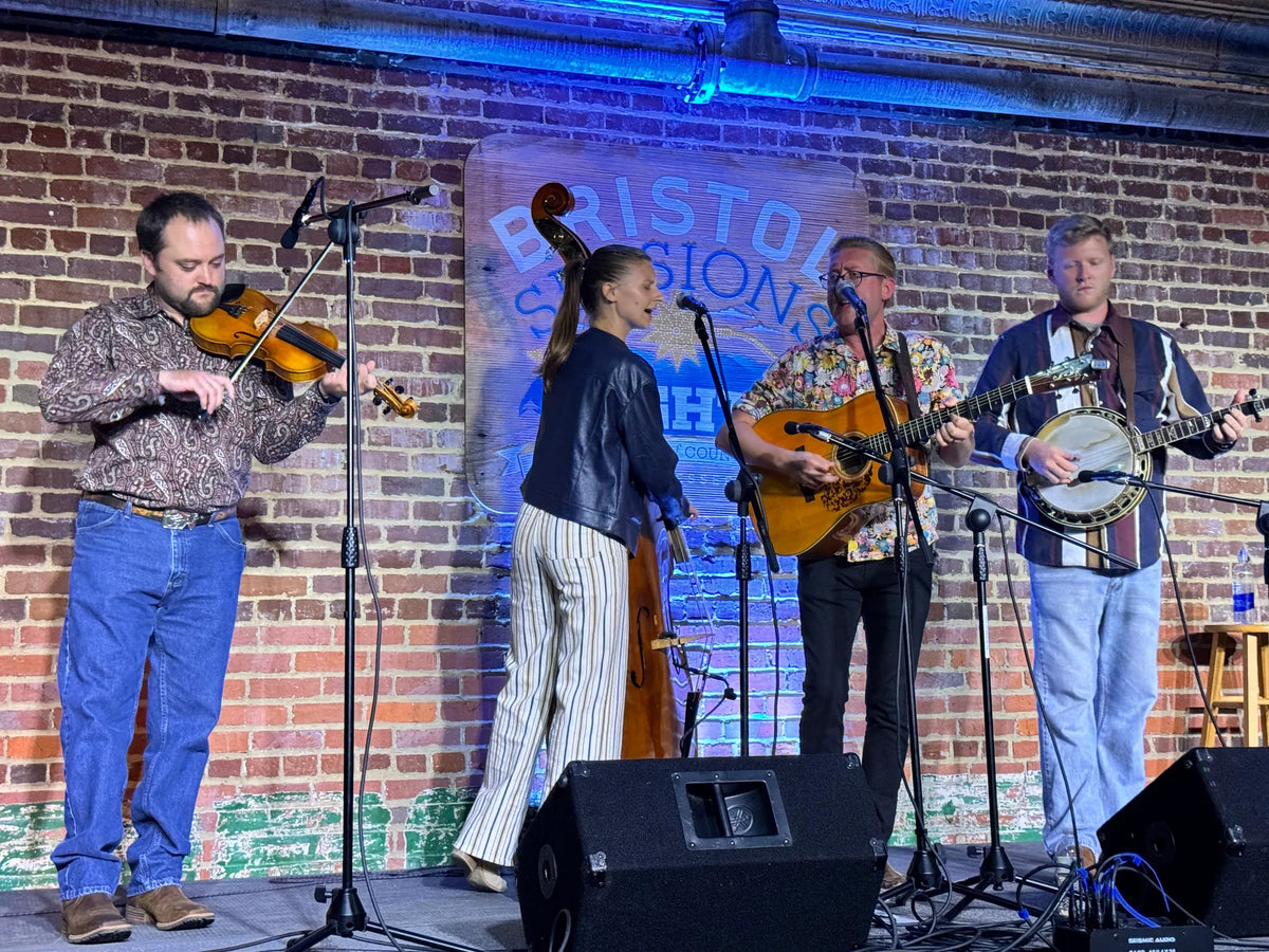 Alex Leach and his band performing under the Bristol Sessions Nights sign at Bristol Sessions Nights: Mountain Songs, Bristol Listening Room, L.C. King Building, Bristol, Tennessee