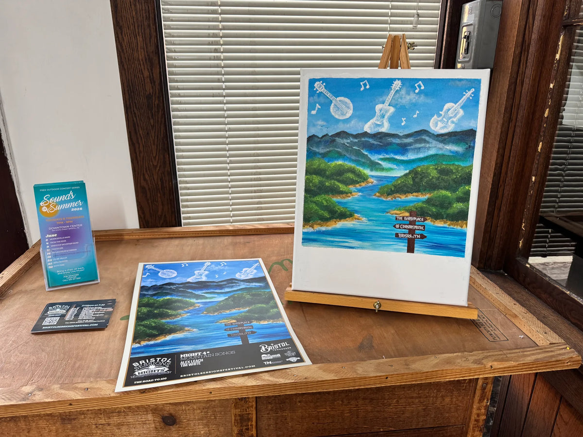 A mountain landscape painting and event programs displayed on an easel at Bristol Sessions Nights: Mountain Songs, Bristol Listening Room, L.C. King Building, Bristol, Tennessee