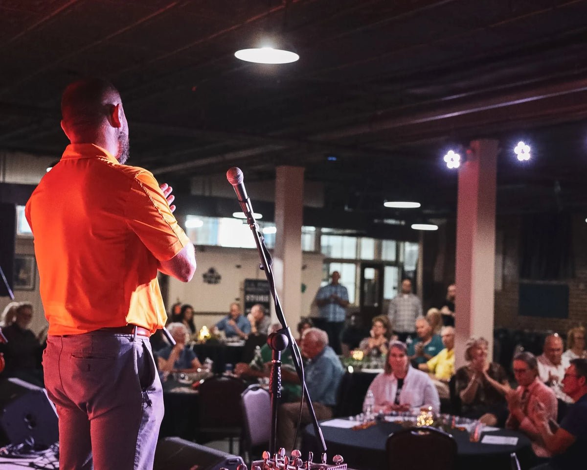 A host welcomes a packed room of guests seated at tasting tables at Bristol Sessions Nights: A True Taste of Tennessee, Bristol Listening Room, L.C. King Building, Bristol, Tennessee