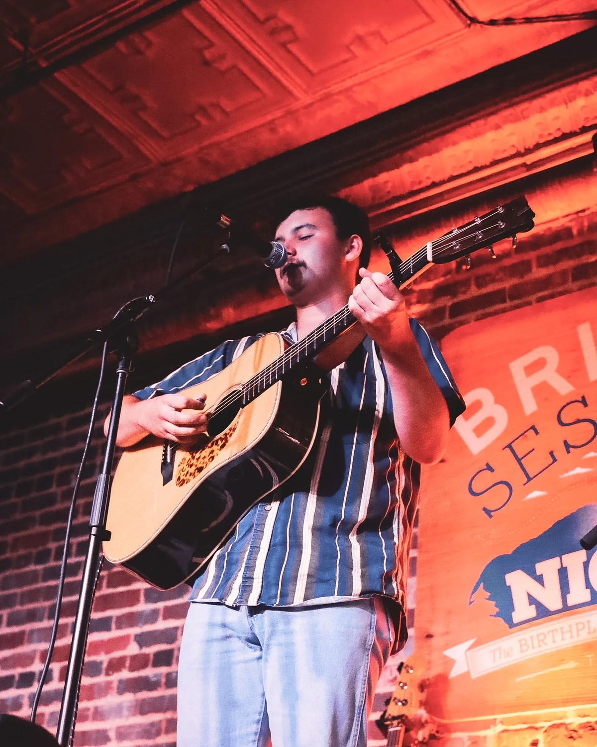 Ryder Casey singing with an acoustic guitar at Bristol Sessions Nights: A True Taste of Tennessee, Bristol Listening Room, L.C. King Building, Bristol, Tennessee