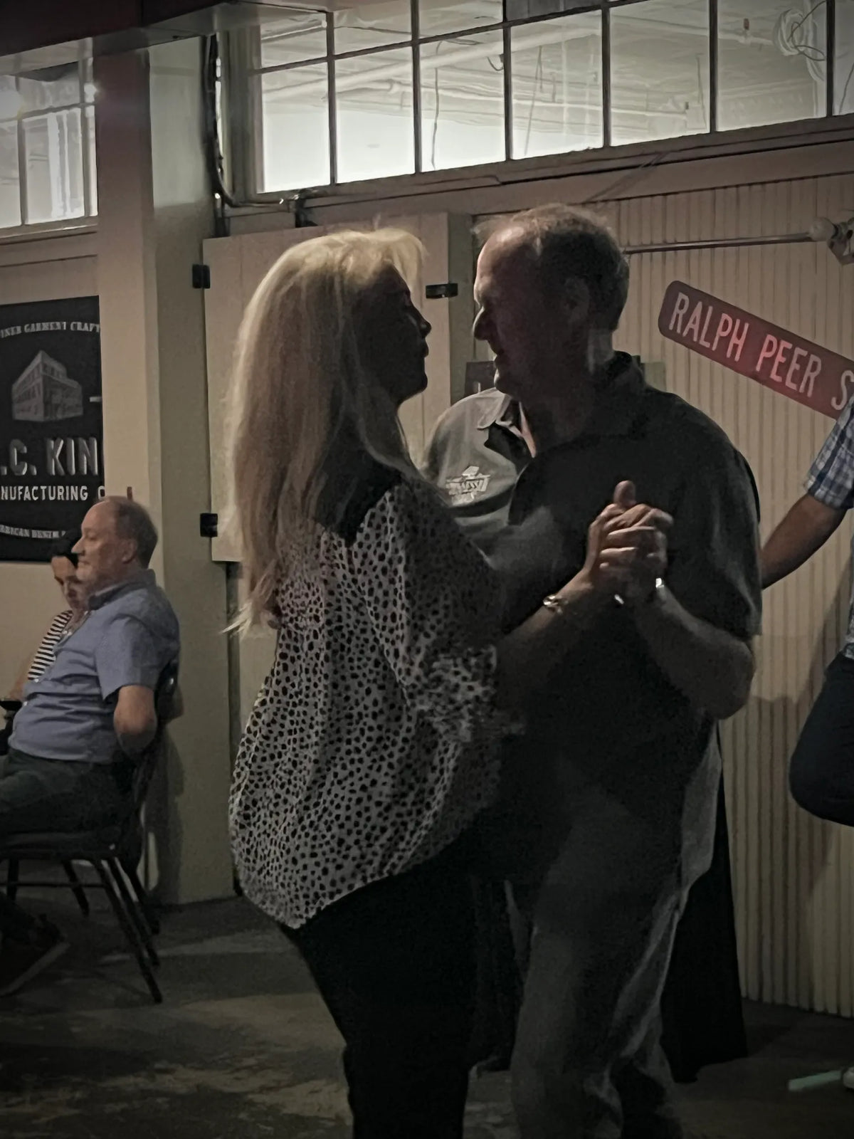 A couple dances beside the Ralph Peer Street sign at Bristol Sessions Nights: A True Taste of Tennessee, Bristol Listening Room, L.C. King Building, Bristol, Tennessee